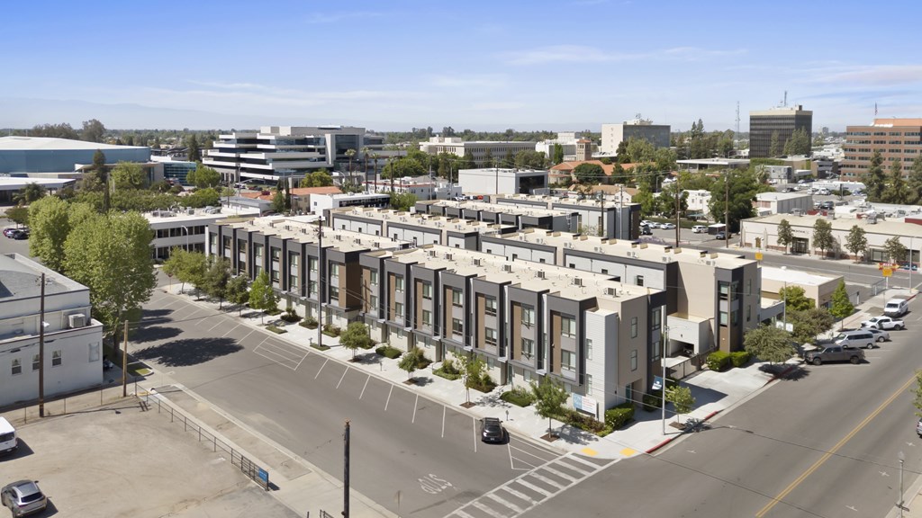 A view of a street with cars and buildings.